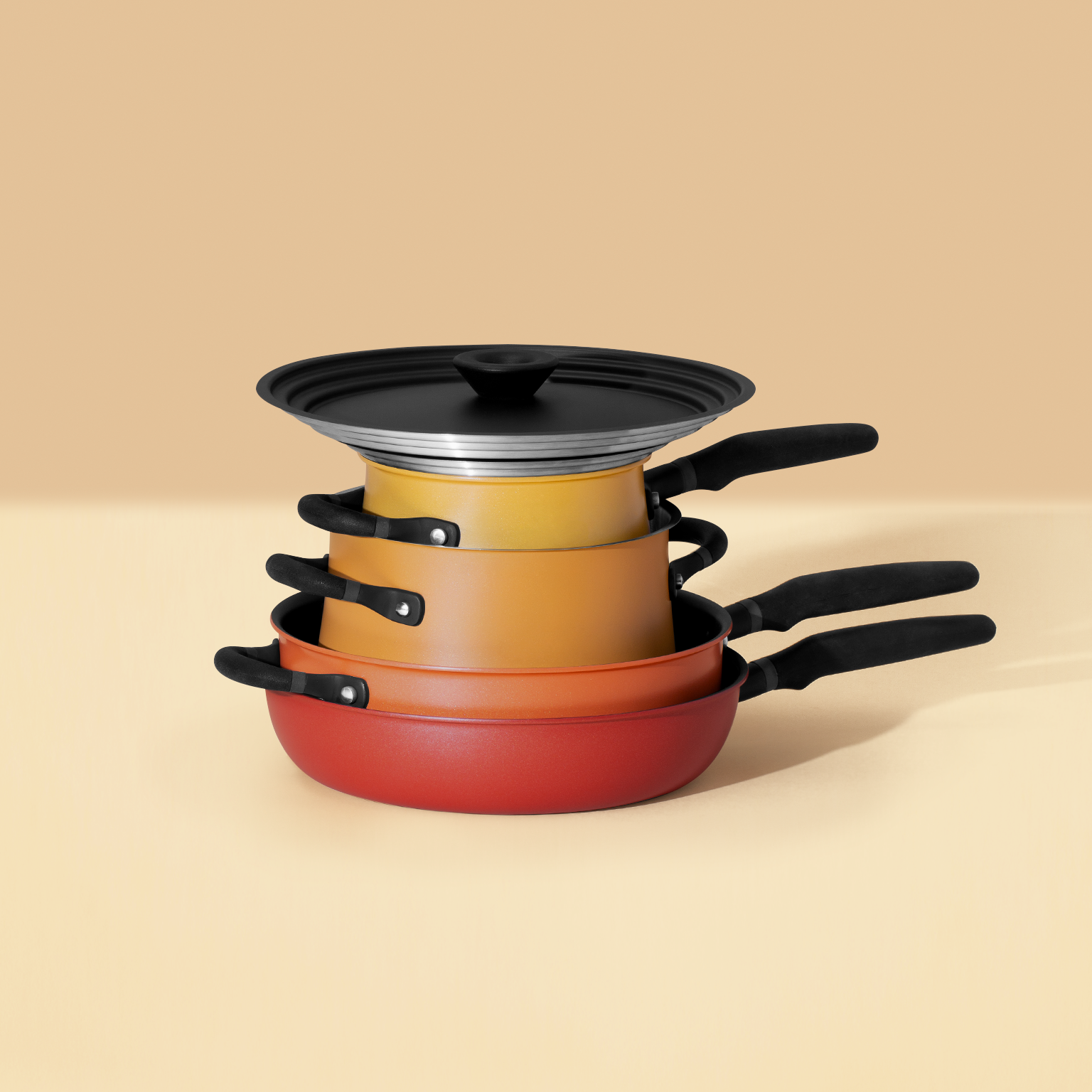 Stackable accent spark cookware set in yellow-orange tone