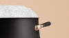 Close-up of the top edge of a Meyer stainless steel stockpot with boiling food that didn't boil over