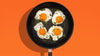 four sunny-side up eggs served with Meyer nonstick skillet
