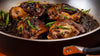 Close up of the Saucy Adobo Chicken served on a Meyer stainless steel searing pan