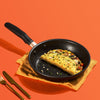 Accent nonstick skillet with omelets and utensils